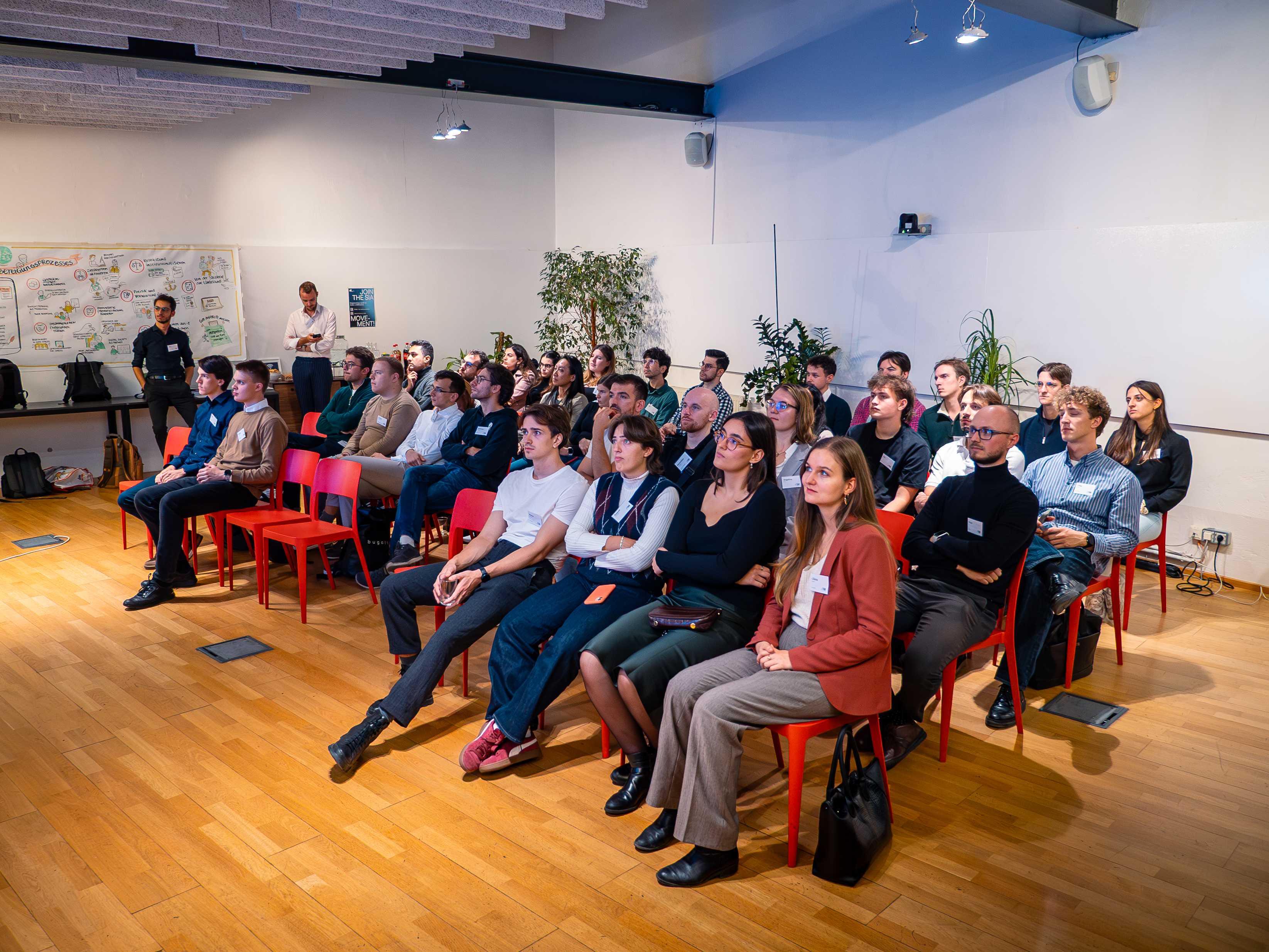 Audience gathered at Impact Hub Vienna for AIM Hackathon 3