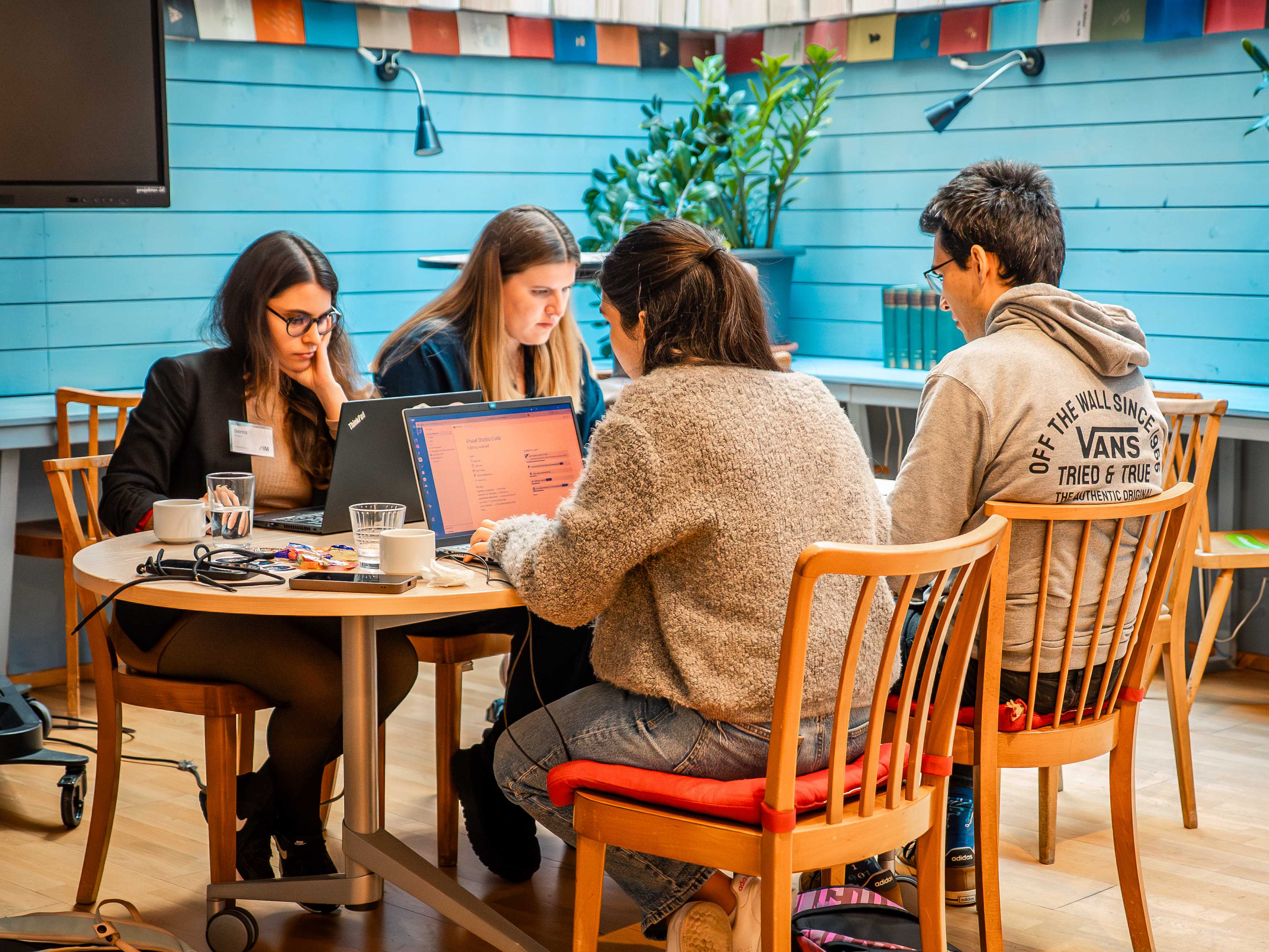 Teams working intensely on their AI agents during the hackathon
