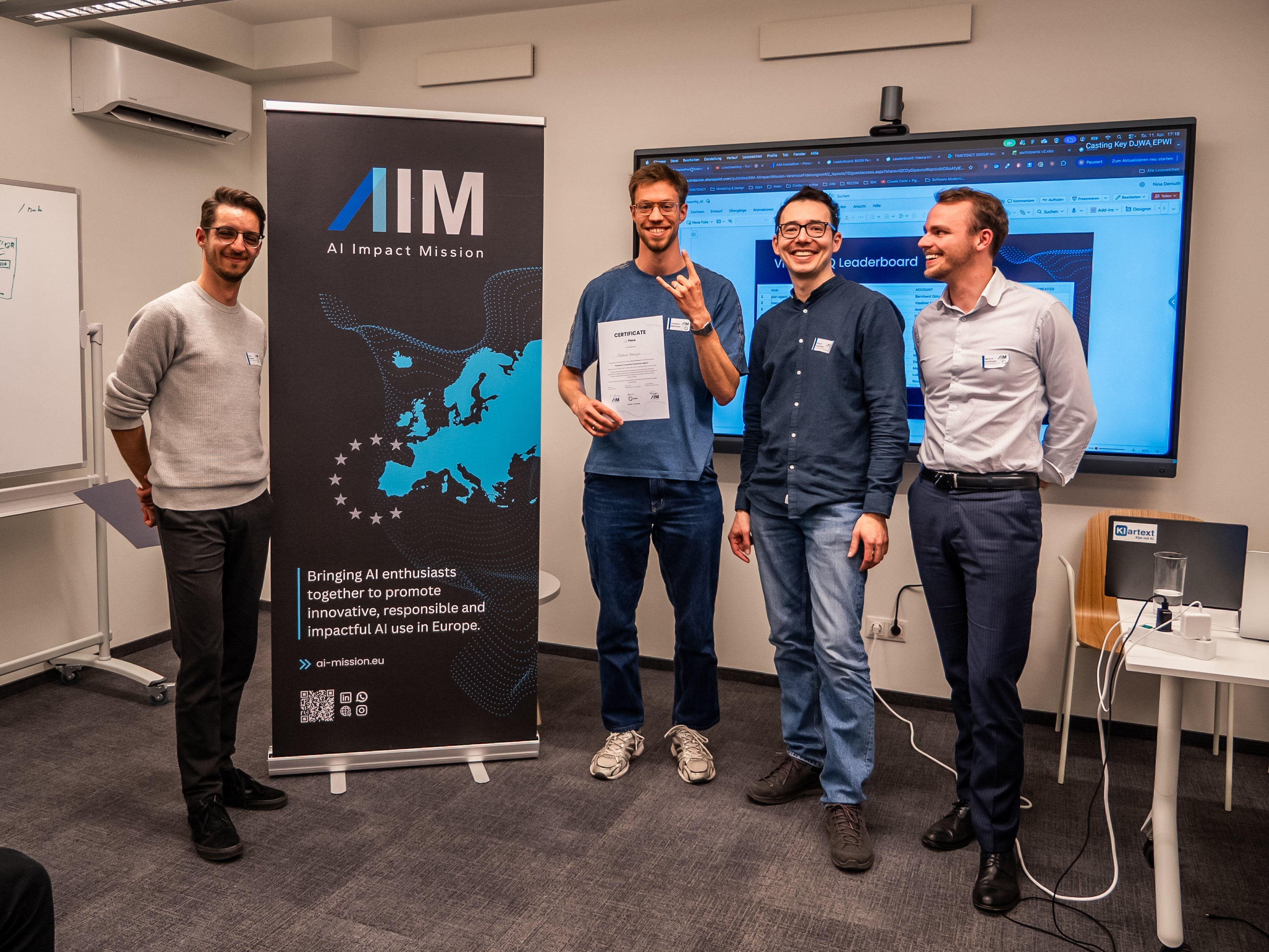 Vladimir Manuilov holding the second-place certificate at AIM Hackathon 4